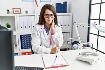Young doctor woman wearing doctor uniform and stethoscope at the clinic touching mouth with hand with painful expression because of toothache or dental illness on teeth. dentist