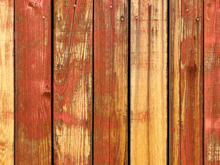 Fototapeta premium red yellow orange painted fading weathered backyard garden fence wood boards architectural background