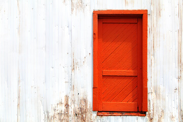 bright orange vintage retro barn farm building door doorway entrance paint rust architectural background
