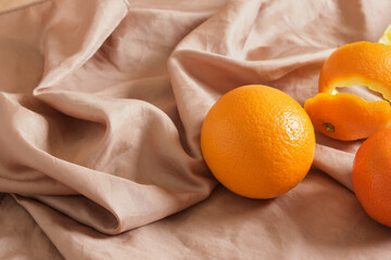 fruit and orange peel on beige soft cloth, fabrics from juice production waste, orange fiber,...