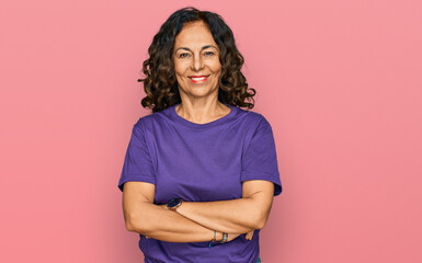 Fototapeta premium Middle age hispanic woman wearing casual clothes happy face smiling with crossed arms looking at the camera. positive person.