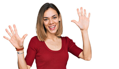 Young blonde girl wearing casual clothes showing and pointing up with fingers number ten while...