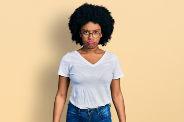 Young african american woman wearing casual white t shirt depressed and worry for distress, crying angry and afraid. sad expression.