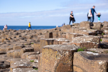 Defocused people walking on basalt columns at Giant’s Causeway, Northern Ireland