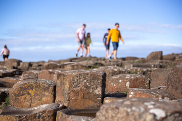 Defocused people visiting Giants Causeway