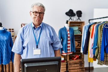 Senior man with grey hair working as manager at retail boutique skeptic and nervous, frowning upset because of problem. negative person.