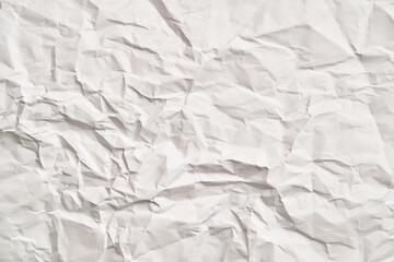 White crumpled paper texture with wrinkles. Damaged and torn sheet
