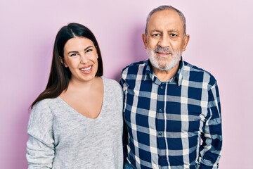 Hispanic father and daughter wearing casual clothes with a happy and cool smile on face. lucky person.
