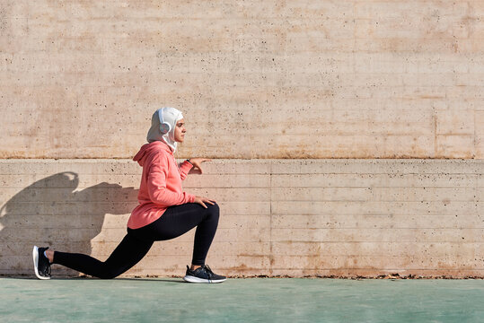 Woman with muslim sport wear stretching