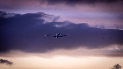airplane in the sky at sunset, taking off during blue hour