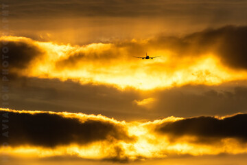 airplane in the sky, aircraft taking off during golden hour