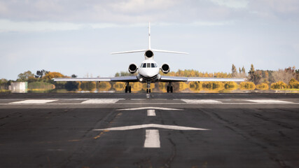 Jet plane taxing on the runway about to take off. Private business aircraft. Taking off, departure.