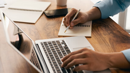 Students learn online classes using a laptop computer and writing notebooks at the workplace, online working, E-learning,  concepts.