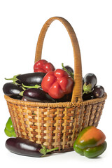 Eggplant and sweet bell pepper in a wicker basket on a white background. Full depth of field. With clipping path