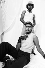 Malaysian Indian men posed in front of a cloth backdrop in a studio setting
