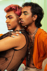 Malaysian Indian men posed in front of a cloth backdrop in a studio setting