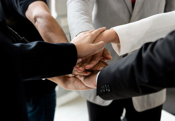 Power of the new generation, Team work, Join forces to achieve the goal. Business people, managers, employees shaking hands, energizing in a circle. The organization grow with the power of the team.