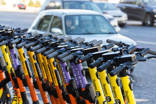 Moscow, Russia - October 14, 2021:  Street parking with electric multi-colored electric scooters Yandex go, Whoosh, 
