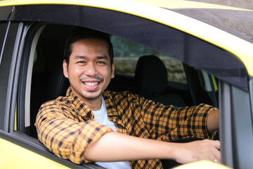 Adult Asian man smiling happy inside his car driver seat - obrazy, fototapety, plakaty