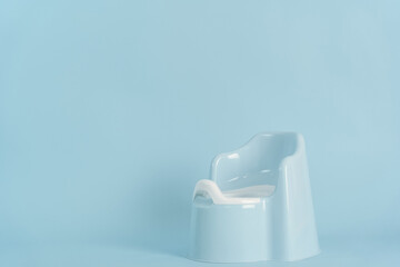 Blue baby potty with a back on a blue background