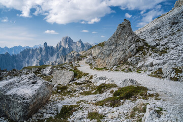 Fototapeta na wymiar Hiking trail to Cime di Lavaredo with Cadini di Misurina mountain group in background. Dolomites, Italy