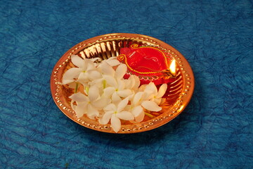 Clay Diya lamps lit with colorful garland during Diwali Celebration. Greetings Card Design Indian Hindu Light Festival called Diwali
