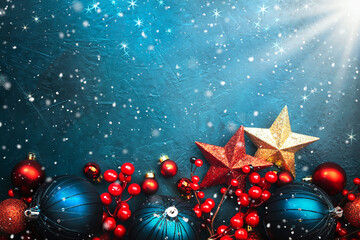 Blue Christmas or New Year background with blue Christmas balls, red berries and stars with...