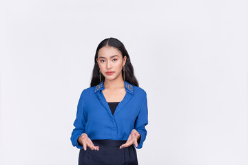 A serious young woman in a blue blouse. Gesturing with both hands in line with her waist. Possibly...