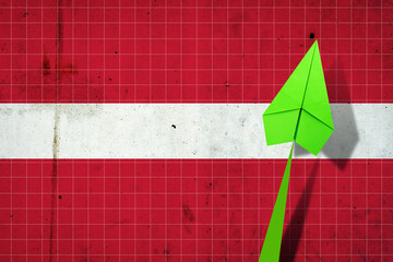 Upward arrow on the background of the flag of Latvia. Paper plane. Economic recovery. Copy space.3D illustration. - obrazy, fototapety, plakaty