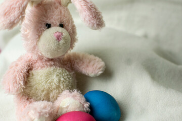 Easter pink bunny with blue eggs. Easter concept.