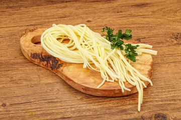 Chechil spaghetti cheese over board