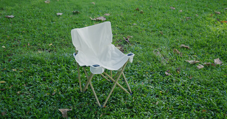 White empty camping chair on the grass