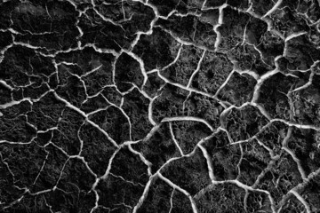 Fototapeta premium abstract black background with white cracks overlay ground cracked drought, old paint