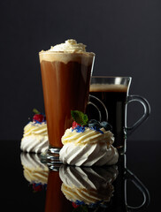 Small Pavlova desserts with raspberry, blueberry, and mint.