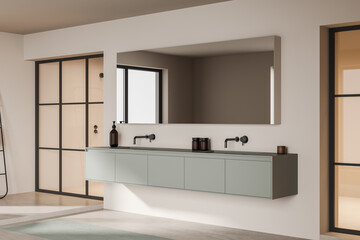 Light bathroom interior with sink and mirror, shower behind glass doors