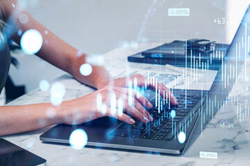 Businesswoman hands using laptop, graph changes with bokeh lights