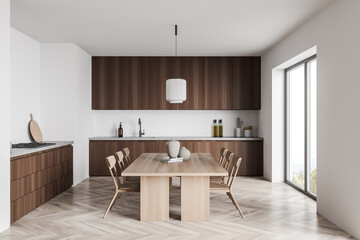 Dark wood kitchen with light wood dining table