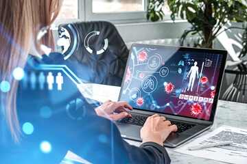 Businesswoman using laptop in office room, screen with medical tests