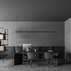 Dark office room interior with desktop, comfortable armchair