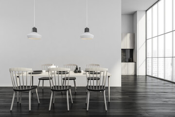 Modern black and white dining room with panoramic kitchen on background