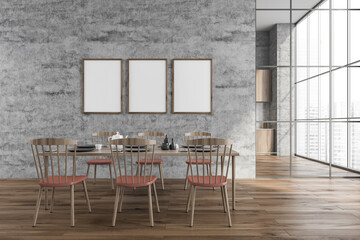 Three frames on grey wall of dining room with pink details