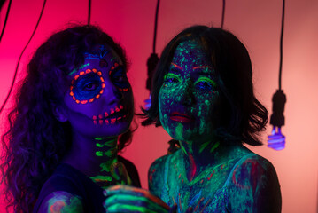 Neon Halloween make up for Day of the Dead celebration in Mexico. Ultra violet neon portrait...