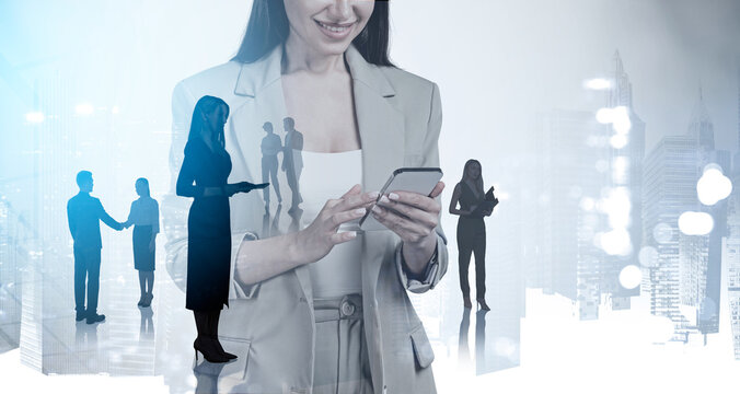 Businesswoman and teamwork in international company with blurred buildings