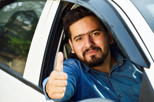 Indian car drive showing thumps up form car's open window
