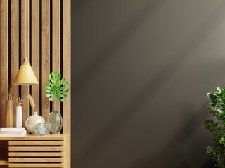 Mockup dark wall with ornamental plants and decoration item on wooden cabinet.