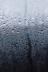 Misted glass. Rain outside the window. Water paths. For the background.