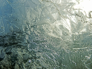  Natural picture of frozen window with ice patterns on sunrise early in the morning