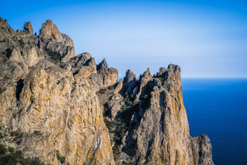 Sheer cliffs near the sea of the volcanic formation Karadag in Koktebel Crimea
