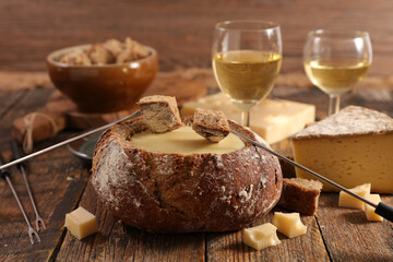 bread with cheese fondue and glasses of wine