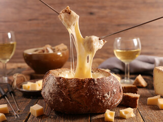 bread with cheese fondue and glasses of wine